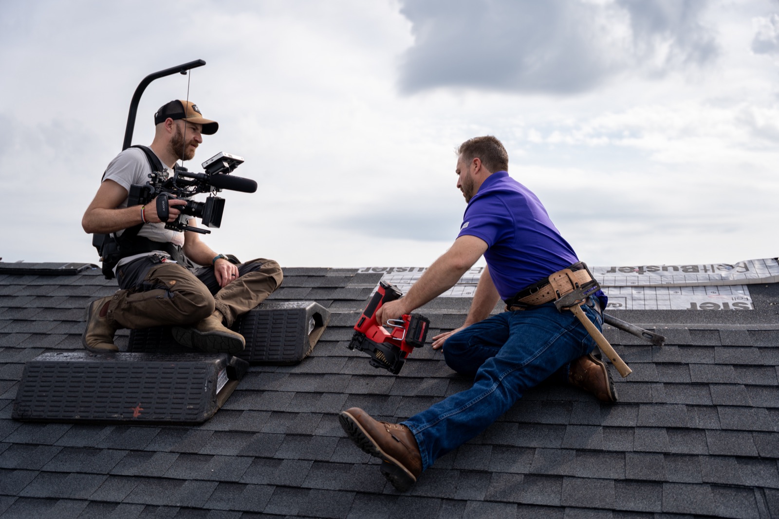 A Wilbur videographer filming a roofer at work on a roof